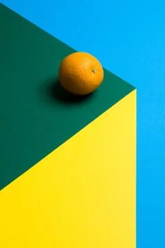 Fruit of orange on a multicolored background, halves of oranges on colored paper Stock Photos