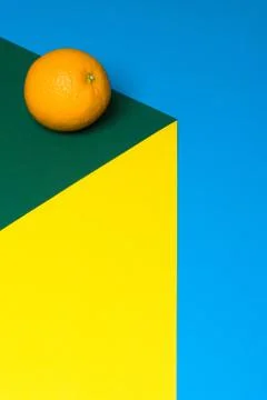 Fruit of orange on a multicolored background, halves of oranges on colored paper Stock Photos