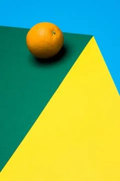 Fruit of orange on a multicolored background, halves of oranges on colored paper Stock Photos