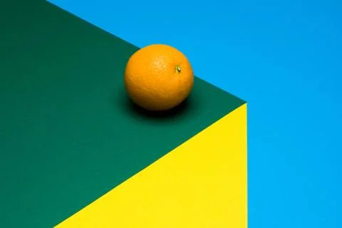 Fruit of orange on a multicolored background, halves of oranges on colored paper Stock Photos