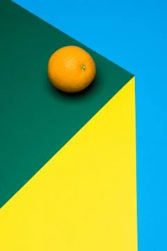 Fruit of orange on a multicolored background, halves of oranges on colored paper Stock Photos