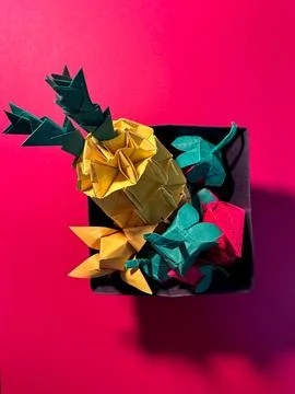 Fruit origami on a red surface Stock Photos