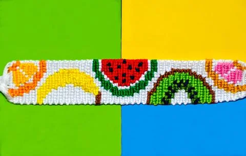 Fruit pattern of braided bracelet handmade of thread on bright three colors.. Stock Photos