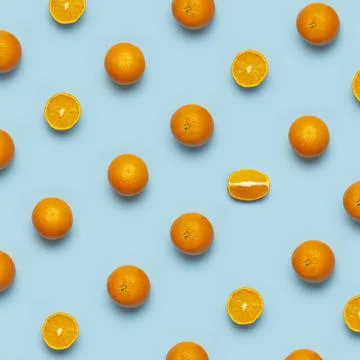 Fruit pattern, creative summer concept. Fresh juicy whole and sliced orange Stock Photos