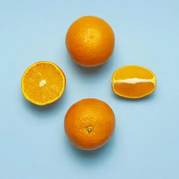 Fruit pattern, creative summer concept. Fresh juicy whole and sliced orange Stock Photos