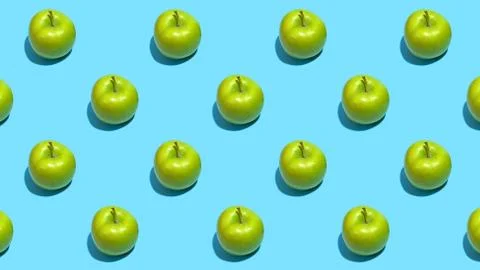 Fruit pattern of fresh green apples on blue background. Top view. Summer conc Stock Photos