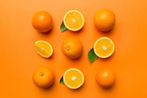 Fruit pattern of fresh orange slices on colored background. Top view. Copy Sp Stock Photos