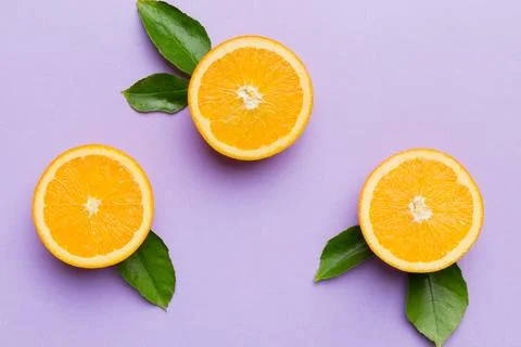 Fruit pattern of fresh orange slices on colored background. Top view. Copy .. Stock Photos