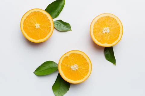 Fruit pattern of fresh orange slices on colored background. Top view. Copy Sp Stock Photos