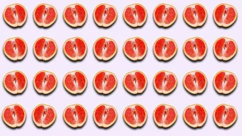 Fruit pattern of half a grapefruit with a shadow on a light background. Stock Photos