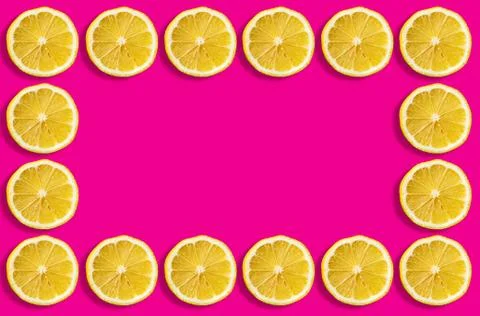 Fruit pattern of lemon slices on a pastel pink background. Copy space Stock Photos