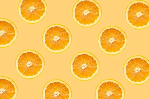 Fruit pattern of orange slices isolated on orange background Stock Photos