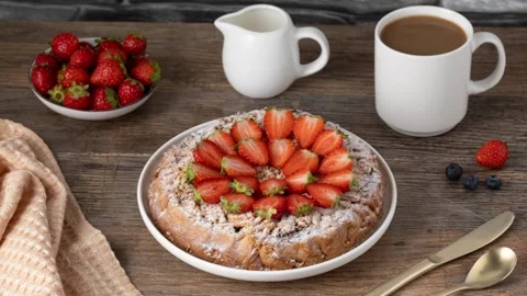 A fruit pie is being decorated with strawberries. Stop-motion animation Stock Footage 345686107