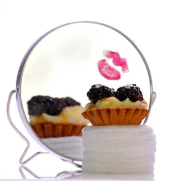 Fruit pie sitting in front of a mirror with lip stick Stock Photos