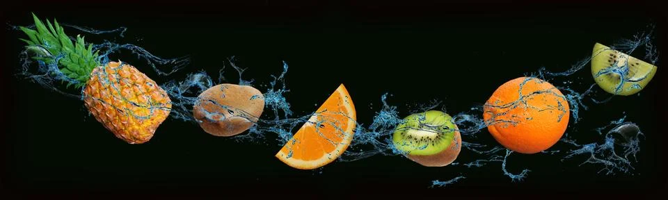 Fruit - pineapple, kiwi, orange on an isolated black and green background Stock Photos
