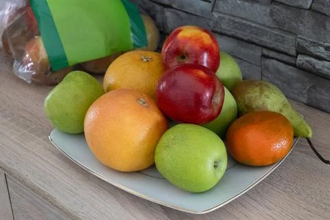 Fruit on plate in kitchen Stock Photos