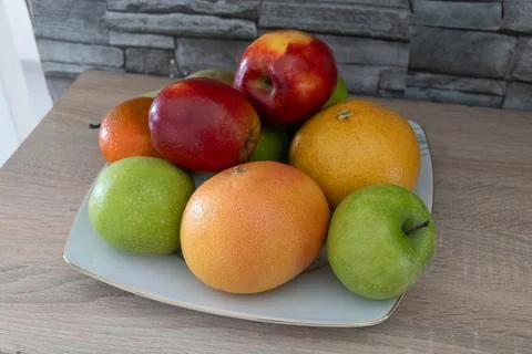 Fruit on plate in kitchen Stock Photos