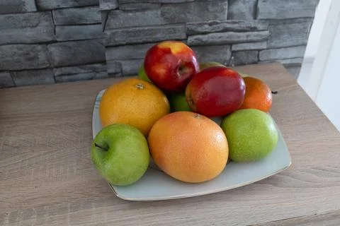 Fruit on plate in kitchen Stock Photos