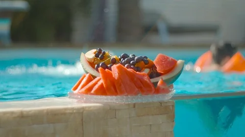 A fruit plate next to a private pool Stock Footage 93876784