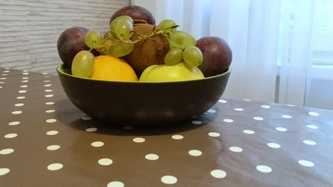 Fruit in a plate on the table. drops of water on the fruit. 6 Stock Footage 98047950