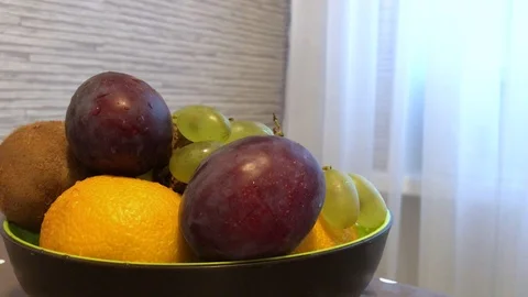 Fruit in a plate on the table. drops of water on the fruit. 5 Stock Footage 98047951