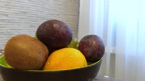 Fruit in a plate on the table. drops of water on the fruit. 3 Stock Footage 98047957