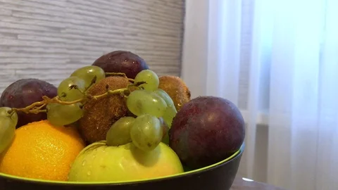 Fruit in a plate on the table. drops of water on the fruit. 2 Video stock 98047973