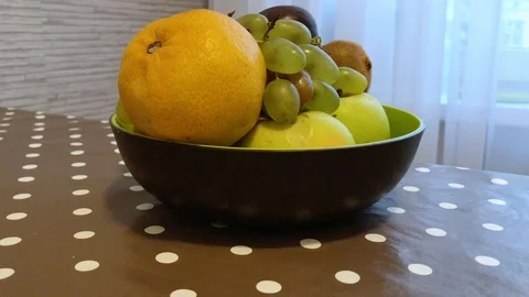 Fruit in a plate on the table. I put the fruit in the bowl. 14 Stock Footage 98047907