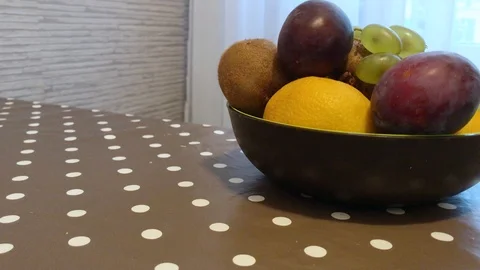 Fruit in a plate on the table. I put the fruit in the bowl. 11 Stock Footage 98047913