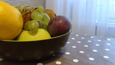 Fruit in a plate on the table. I put the fruit in the bowl. 8 Stock Footage 98047931