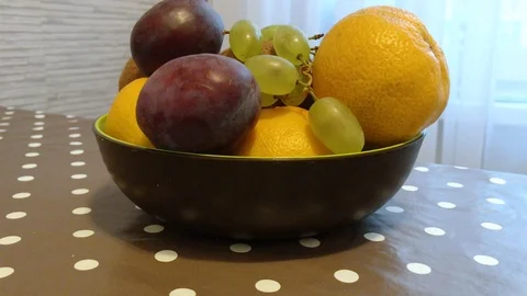Fruit in a plate on the table. I put the fruit in the bowl. 7 Stock Footage 98047935