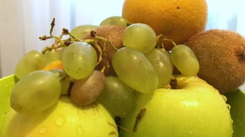 Fruit in a plate on the table. I put the fruit in the bowl. 5 Stock Footage 98047989