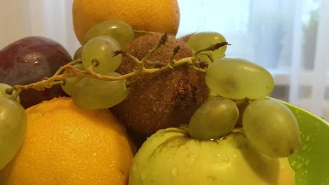 Fruit in a plate on the table. I put the fruit in the bowl. 4 Stock Footage 98047990