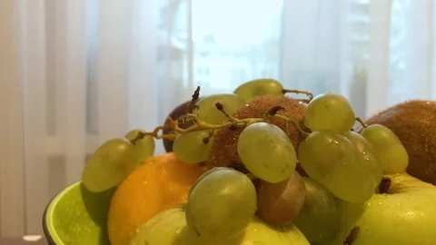 Fruit in a plate on the table. I put the fruit in the bowl. 3 Stock Footage 98047999