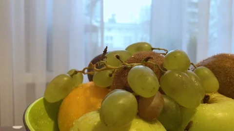 Fruit in a plate on the table. I put the fruit in the bowl. 2 Stock Footage 98048010
