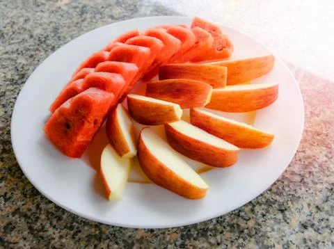Fruit on plate top view / fresh fruit watermelon and apple slice on white pla Stock Photos