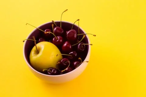 Fruit in a plate on a yellow background. Stock Photos