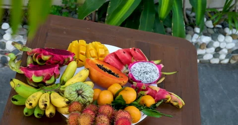 Fruit platter with dragon fruit, kiwi, pineapple, and assorted fresh tropical Stock Footage 314497699