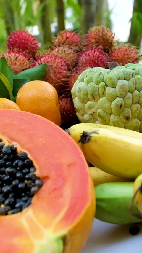 Fruit platter with exotic tropical fruits watermelon papaya pitahaya rambutan Stock Footage 285890556
