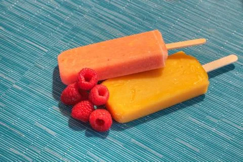 Fruit popsicles on an aqua blue background in summer Stock Photos