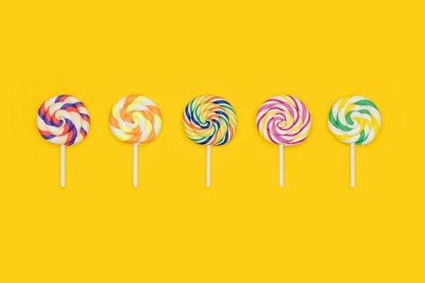 Fruit Rainbow Swirl Flat Lollipops in a row. Lollipop candy set. Stock-Fotos