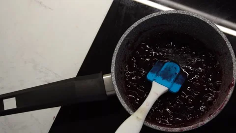 Fruit raspberry jam is cooked on the stove. Video stock 236485409