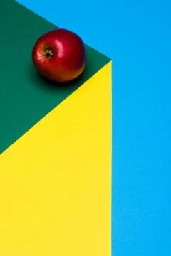 Fruit of red apple on a multicolored background, halves of oranges and apples on Stock Photos