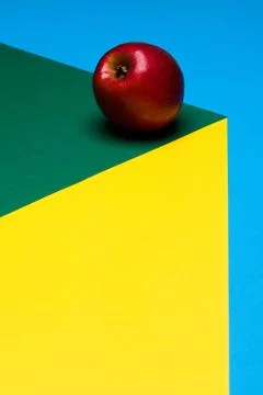 Fruit of red apple on a multicolored background, halves of oranges and apples on Stock Photos