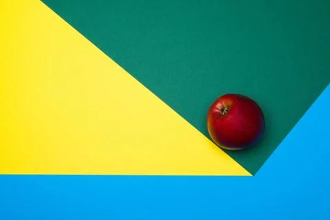 Fruit of red apple on a multicolored background, halves of oranges and apples on Stock Photos