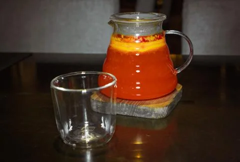 Fruit red tea in a transparent teapot with a glass Stock Photos