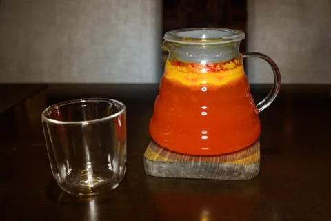 Fruit red tea in a transparent teapot with a glass Stock Photos