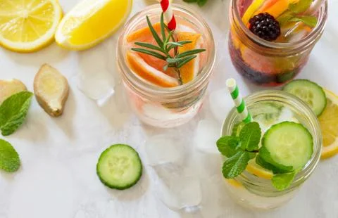 Fruit refreshing water. Summer cold drinks with blackberries, grapefruit. Stock Photos