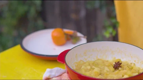 Fruit salad and orange on table at home Stock Footage 76198807