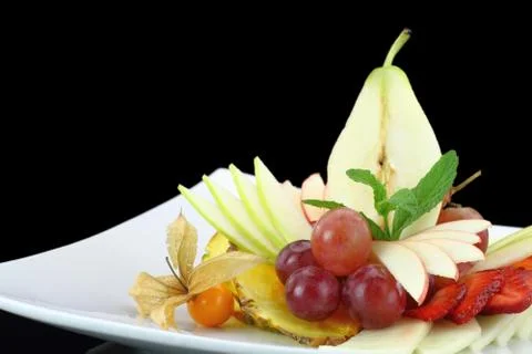 Fruit salad on black background Stock Photos